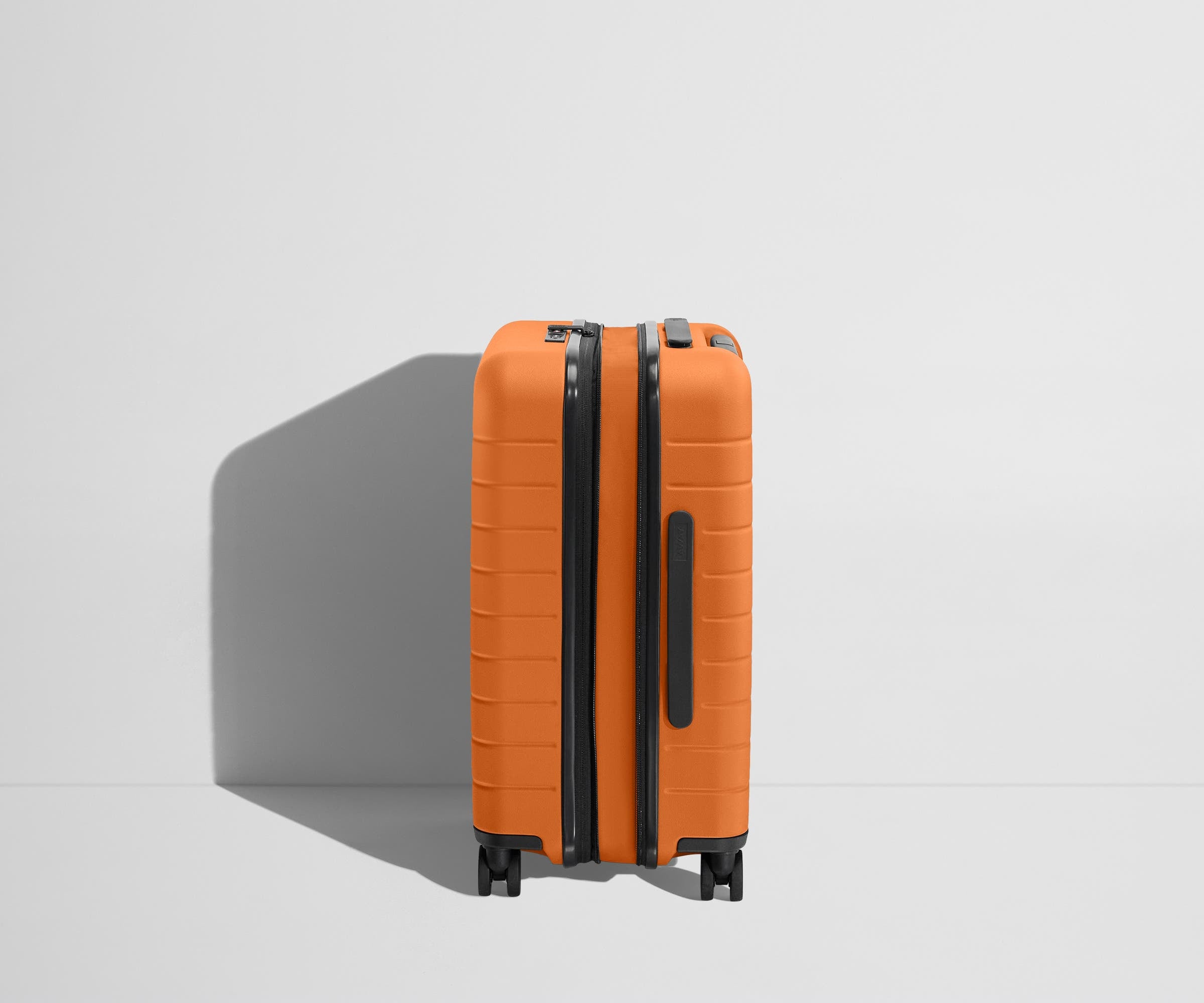 Side product view of The Carry-On Flex suitcase in Sorbet Orange shown fully expanded