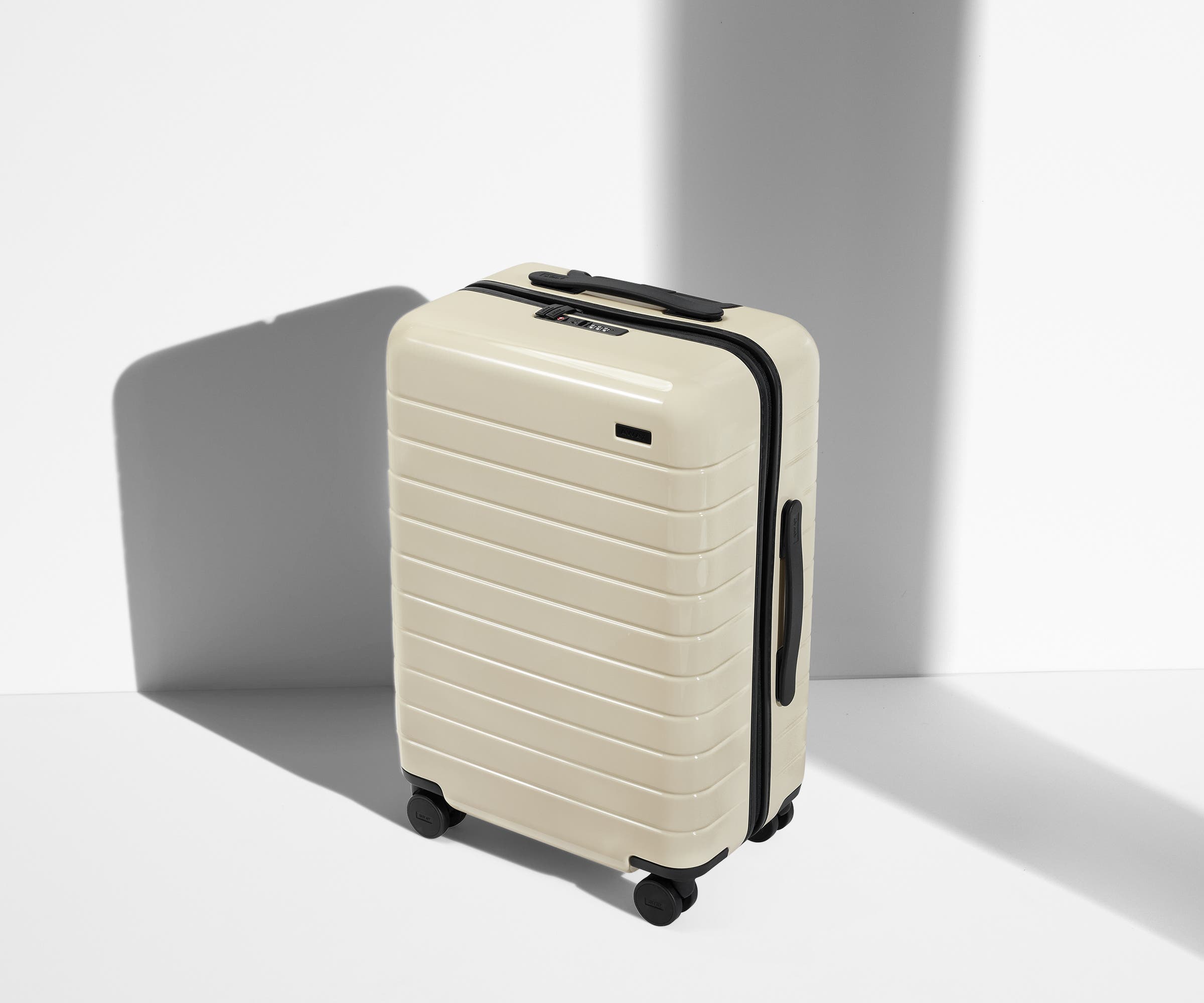 Angled product view of The Bigger Carry-On suitcase in Salt White (Gloss)