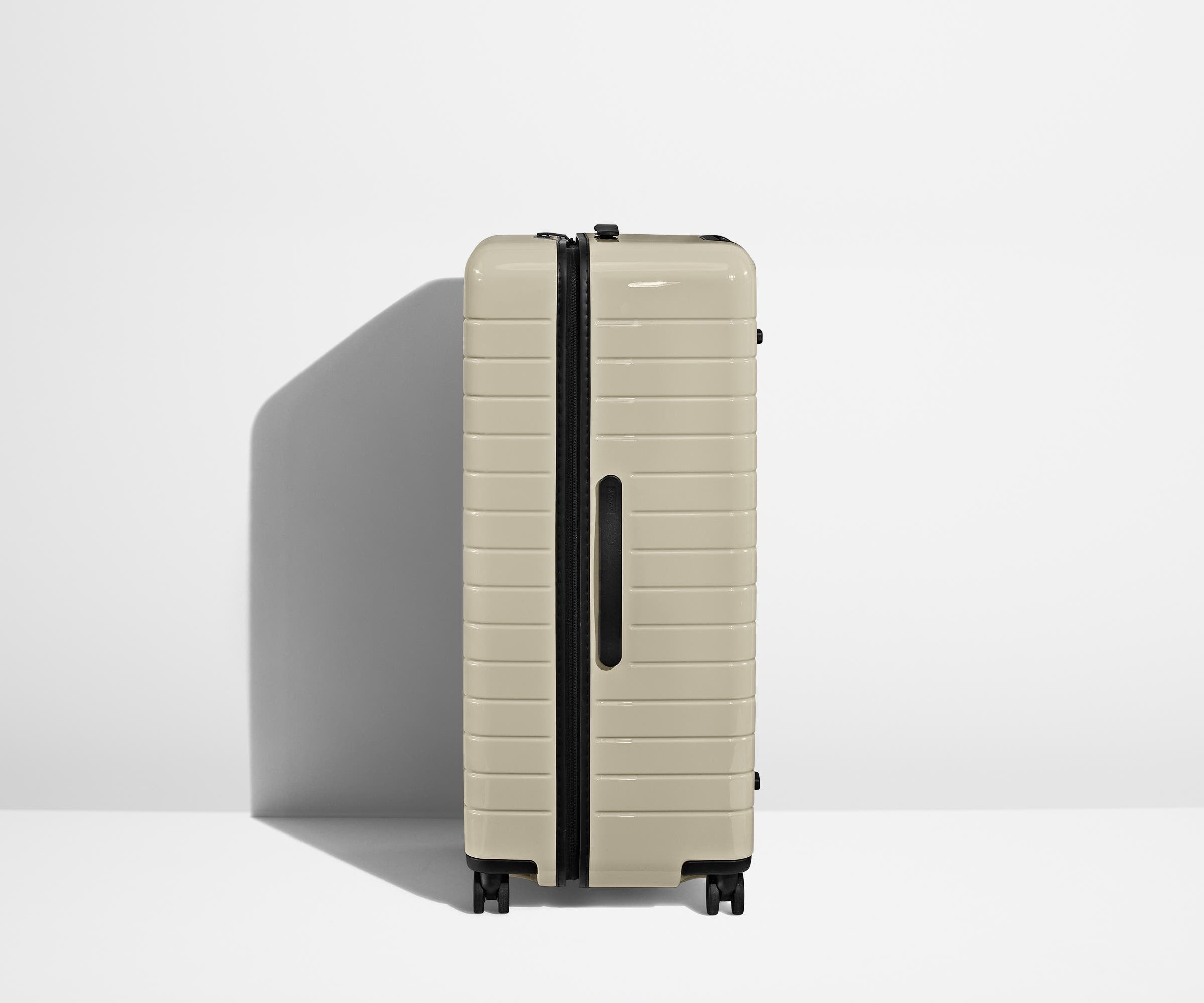 Side product view of The Trunk suitcase in Salt White (Gloss) to show the slimmer top lid and deeper main compartment for easy access and packing