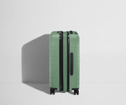 Side product view of The Bigger Carry-On Flex suitcase in Sea Green shown fully expanded