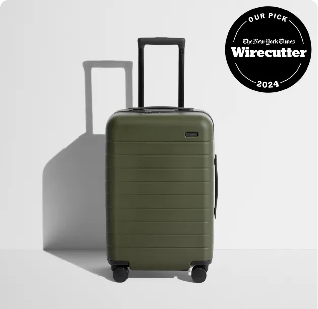 The Away Bigger Carry-on suitcase in olive green with a NYT Wirecutter 2024 badge