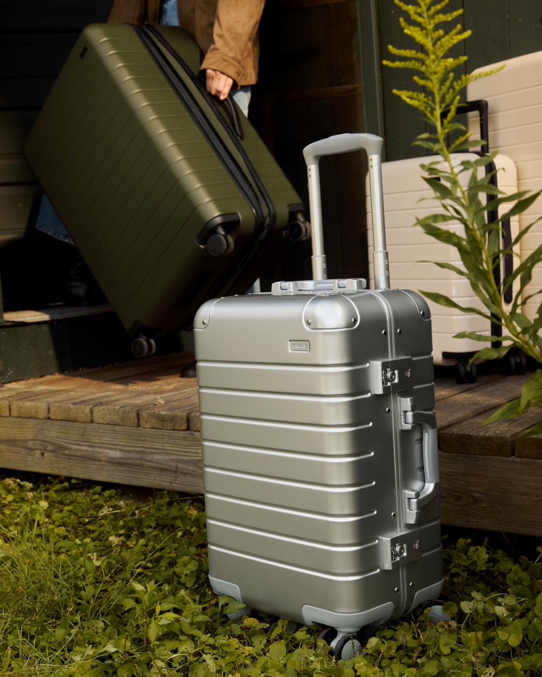 a Large Away suitcase in olive green and a, Away Bigger Carry-on Aluminum in silver