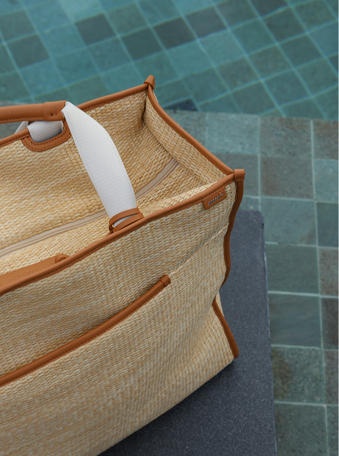 A close up of an Away x White Lotus Poolside Tote