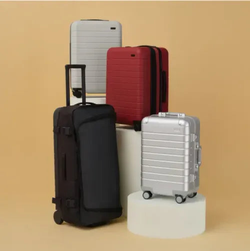 A stack of Away suitcases on a white background
