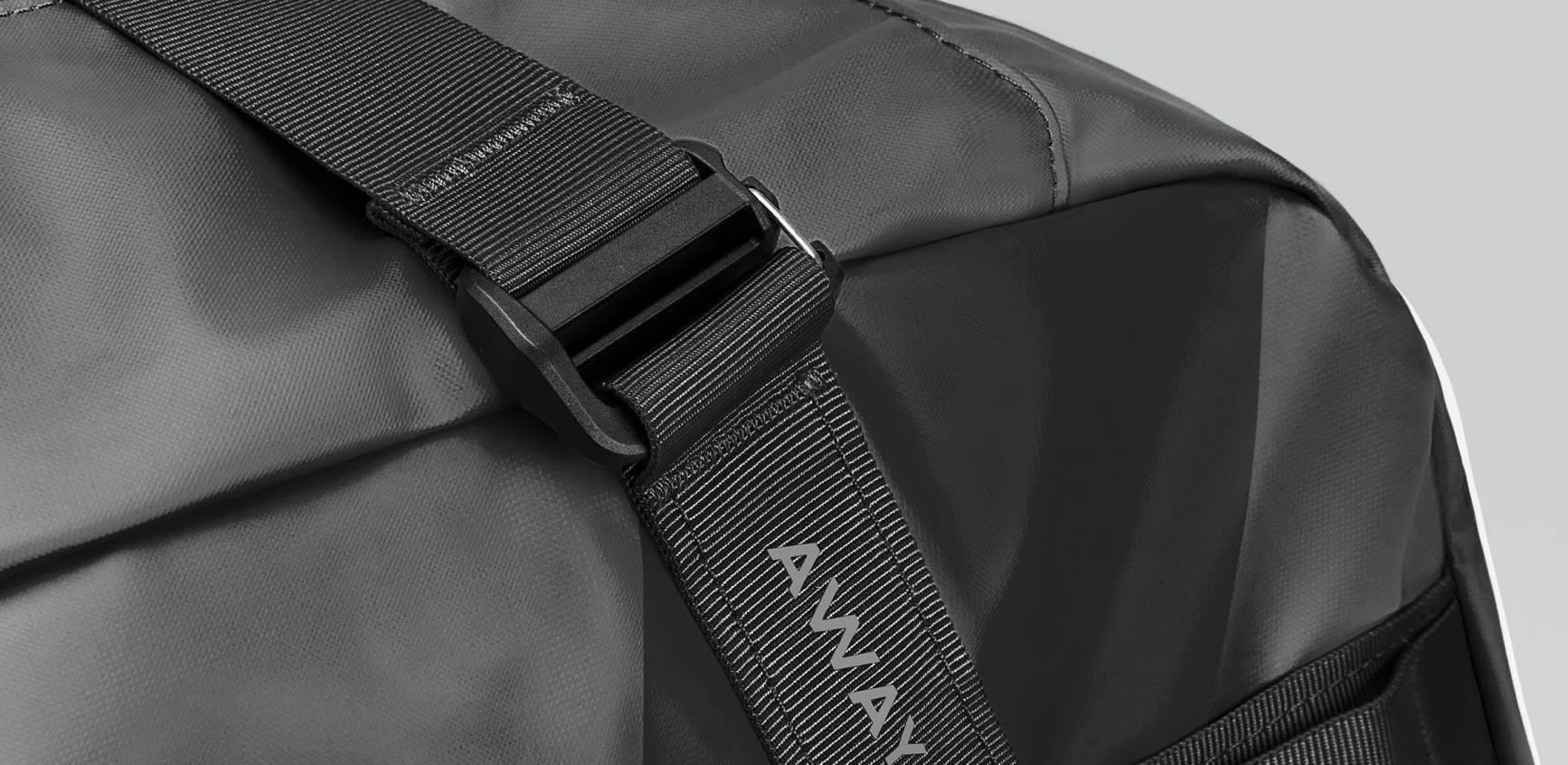 A close up shot of an Away Active duffle  strap clip
