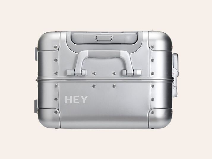 An Aluminum Away suitcase with engraving on the top left of the suitcase