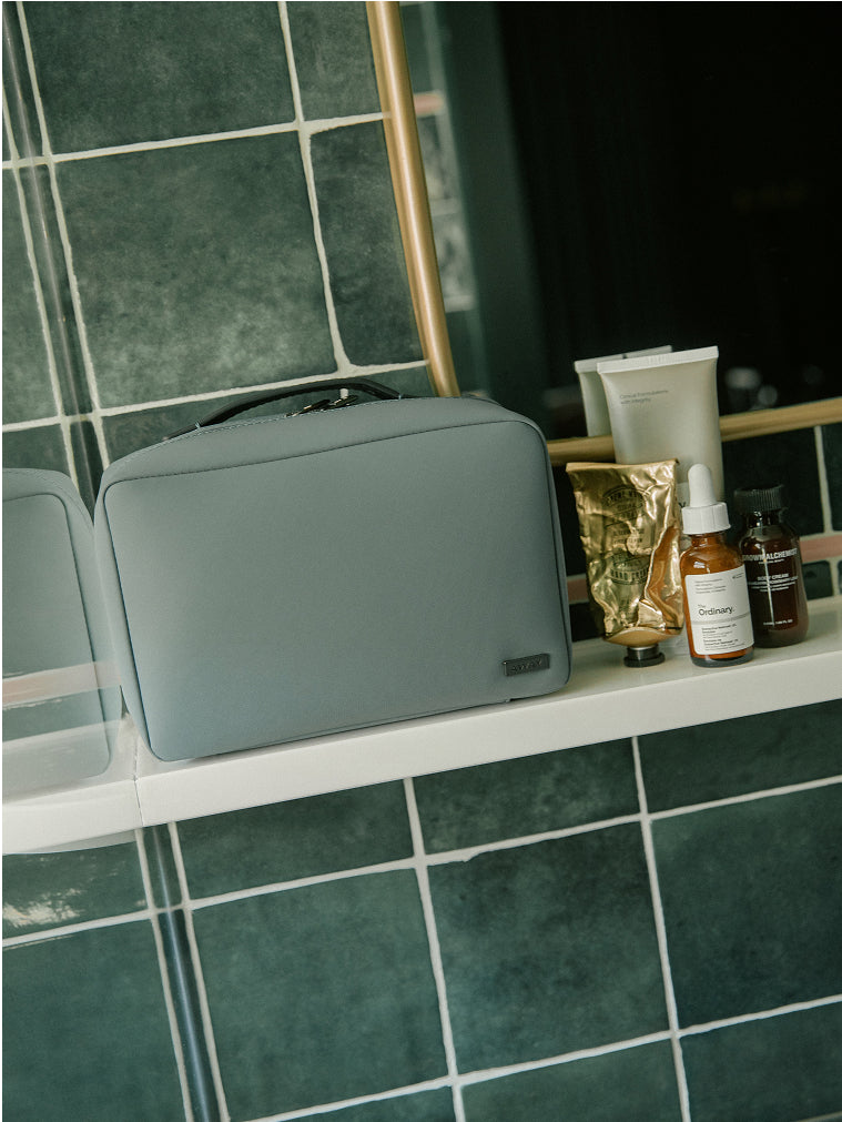 Blue toiletry bag on a bathroom vanity