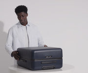 Person packing their Medium suitcase