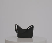 Video of a person packing and wearing the Crossbody bag