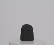 Person packing the Large Featherlight Backpack