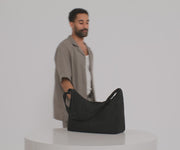 Video of a person packing the Large Featherlight Crossbody bag