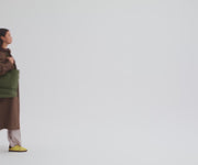 Person packing the Double Diaper Tote and attaching to the stroller