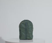 Main compartment packed with an organizational pouch, notebook, and headphones. Water bottle in the exterior water bottle pocket