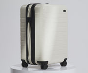 A 360° view of The Bigger Carry-On suitcase in Salt White (Gloss), showing the gloss finish.